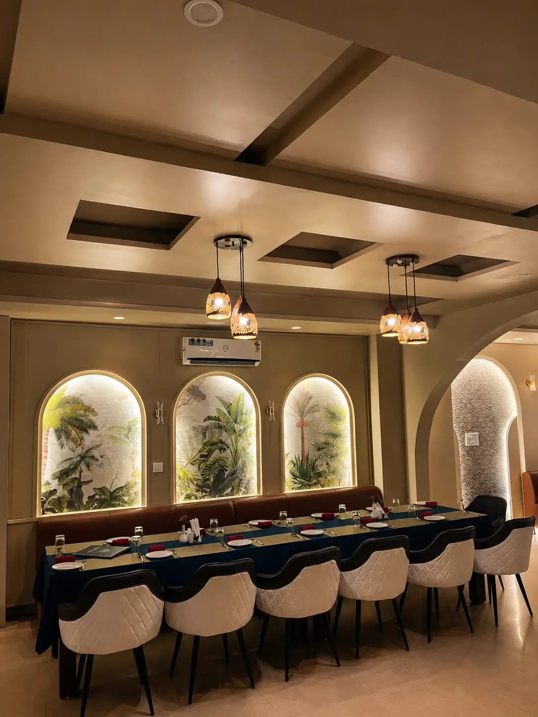 Dining area setup at Hotel H Plus with table seating and warm interior lighting