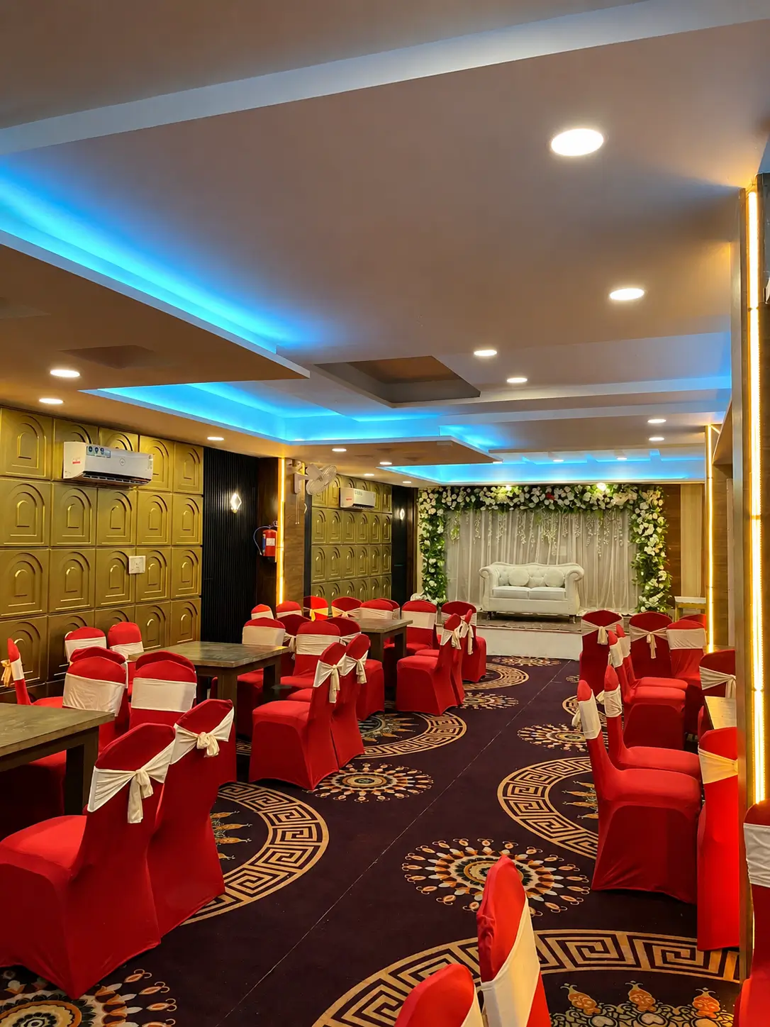Event hall setup at Hotel H Plus with stage seating and banquet arrangement
